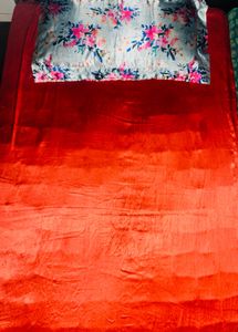 Satin bedcover with floral pillow