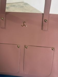 Brand Mochi Pink Solid Handheld Bag,has a Zip Closure 1 Main Compartment Two Handler