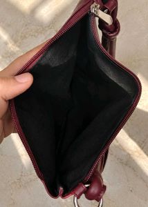 Clinique burgundy Leather Bag.