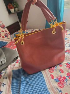 Chic Maroon Handbag with Gold Chain Accents