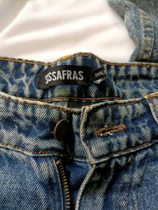blue washed jeans with heart shape cut out .