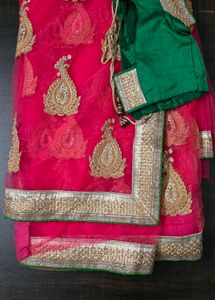 Pink net saree with blouse and satin peticot