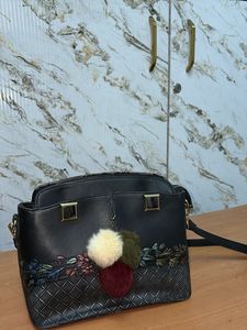 Chic Black Handbag with Pom-Pom Charm