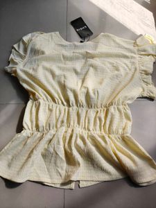 Cream Textured Peplum Top with Bows