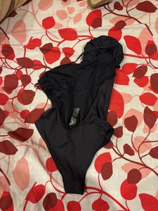 Chic Black One-Shoulder Top with Flower Accent