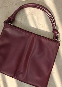 Clinique burgundy Leather Bag.