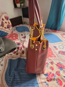 Chic Maroon Handbag with Gold Chain Accents