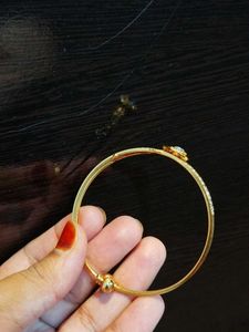 Elegant Gold Tone Bangle Bracelet with CZ Stones