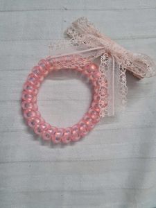 Two coquette lana coded bracelets
