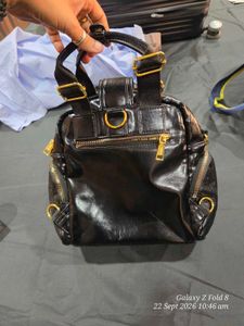 Chic Black Patent Clutch Bag with gold detailing.