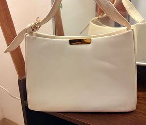 White Handbag With A Golden Buckle