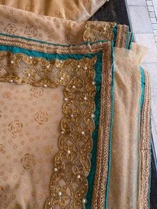 cream colour saree with peacock blue blouse