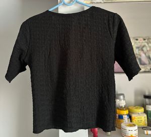 Chic Textured Black Top with Rose Detail