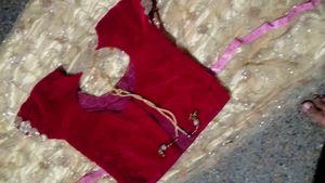 The maroon  lehenga   with golden colour net gown