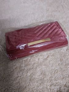 it's new Burgundy Clutch with Gold Detail