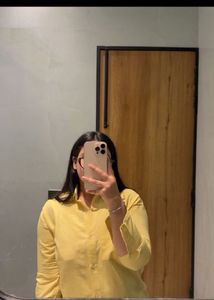 beige yellow shirt and heels