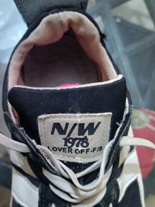 Men black and white stripes shoe.
