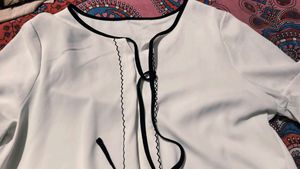Chic White Blouse with Black Trim