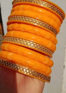 Vibrant Orange Bangle Set with Golden Embellishmen