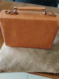 Stylish Tan Handbag with Flower Clasp