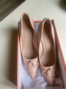 Elegant Nude Patent Bow Pumps