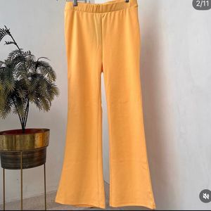 Yellow stretchable flared cotton trousers.