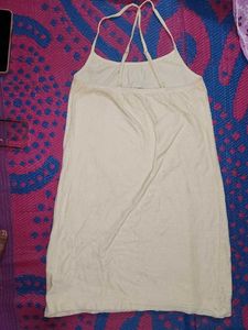 Cream-colored (or off-white) mini dress