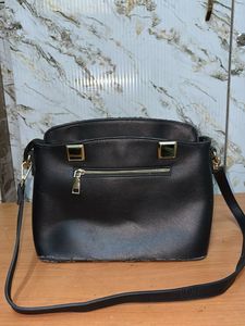 Chic Black Handbag with Pom-Pom Charm