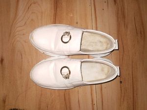 White slip-on shoes with embellishments