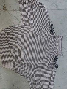 stripped knitted top with pom-poms on sleeve