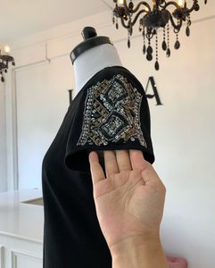 Elegant Black Dress with Embellished Sleeves