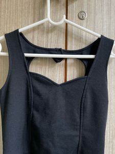 Chic Black Peplum Top with Heart Cutout