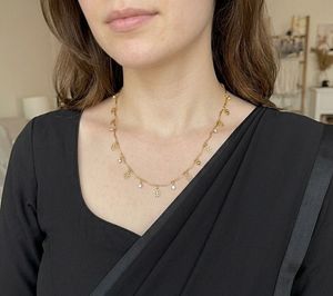 Elegant Gold Necklace with Charms