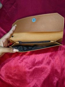 Chic Tan Clutch with Pom-Pom