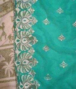 Elegant Teal Saree with Silver Embellishments