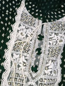 A beautiful dark green short kurti with embellish