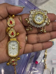 Elegant Gold Tone Watch with Red Accents