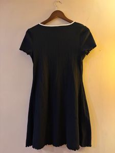 Chic Black Ribbed Mini Dress with Bow Accent