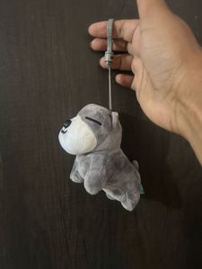 grey and white plush puppy keychain with closed