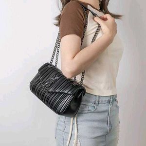 YSLsleek black shoulder bag features striking vert