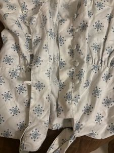 Puff sleeve tie-front top in a soft blue print.