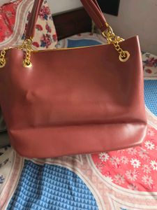 Chic Maroon Handbag with Gold Chain Accents