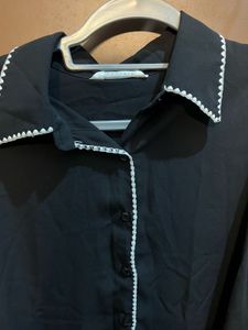 Chic Black Blouse with White Trim