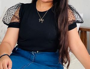 Chic Black Top with Polka Dot Sleeves