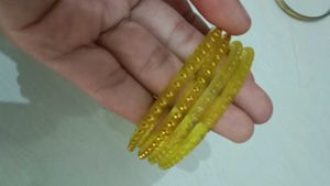 Elegant Yellow Bangles with Golden Embellishments