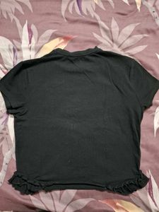 Black "Just a Girl" Cropped Tee with Ruffle Hem
