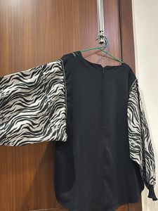 Stylish black top with zebra designed sleeves