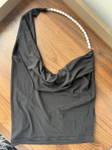 Black backless halter neck top with pearls