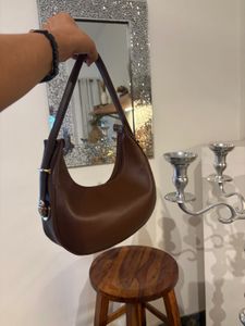 brown sling bag with belt