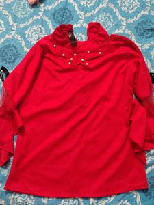 Red Top with pearl design and black bow on sleeves